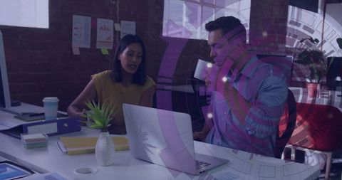 Professionals Collaborating Over Laptop with Modern Data Visualization