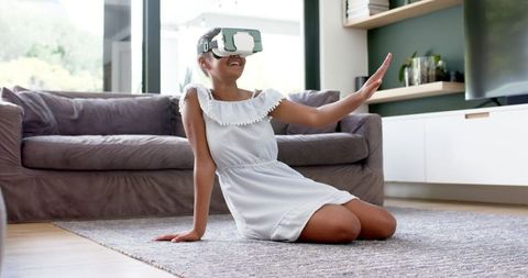 Joyful Girl Exploring Virtual Reality in Modern Living Room