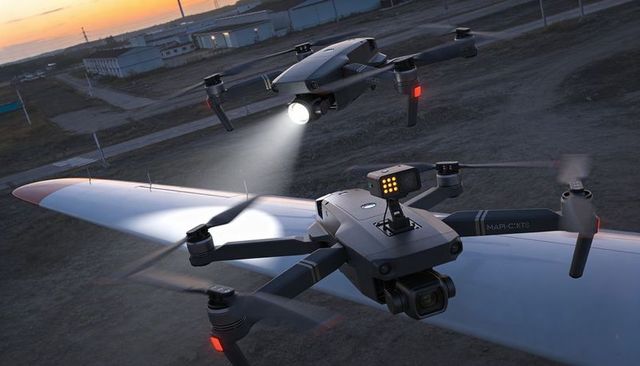 Dual quadcopter conducting dusk runway inspection with spotlight and compact LED sensor module