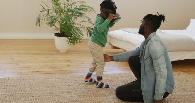 Father Helping Son with Virtual Reality Headset in Minimalist Bedroom - Download Free Stock Images Pikwizard.com