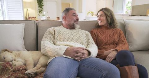 Couple Relaxing at Home with Sleeping Golden Retriever