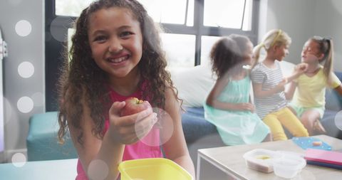 Smiling diverse children enjoying lunch together