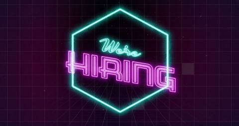 Glowing neon text states 'We're Hiring' in vibrant colors, framed by a hexagon on a dark grid background. Perfect for attracting attention in digital job postings, social media ads, recruitment flyers, and announcements seeking new employees.