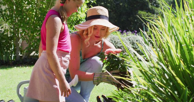 Mother and Young Daughter Gardening Together in Sunny Backyard - Download Free Stock Images Pikwizard.com