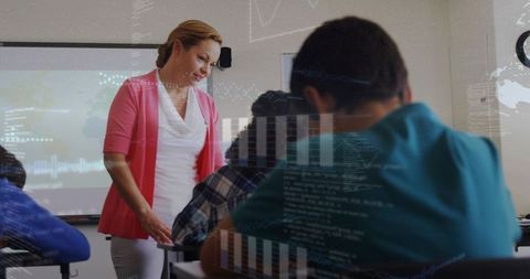 Teacher guiding students in classroom with digital data overlays and projector technology