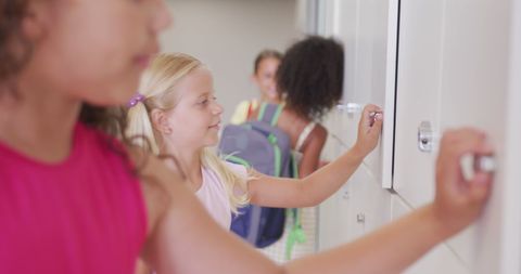 Happy girls embracing school adventures at lockers