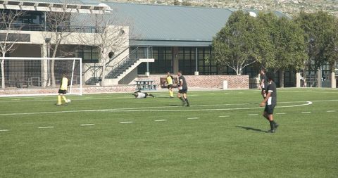 Youth soccer practice on sunny field with active players