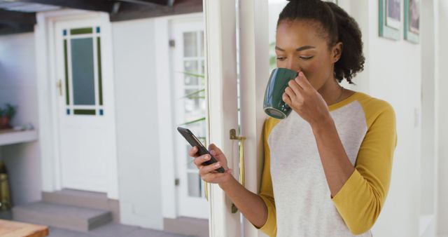 Young Woman Drinking Coffee while Using Smartphone at Home - Download Free Stock Images Pikwizard.com