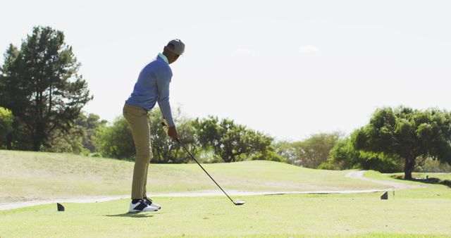 Image of african american man playing golf on golf filed. sporty, active lifestyle and playing golf concept.