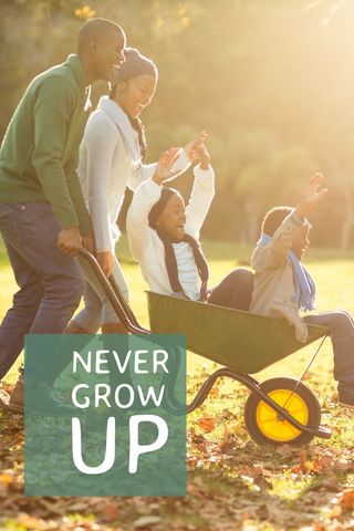 Happy family enjoying playful wheelbarrow ride in sunlit park