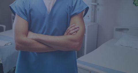 Confident male doctor standing in hospital ward