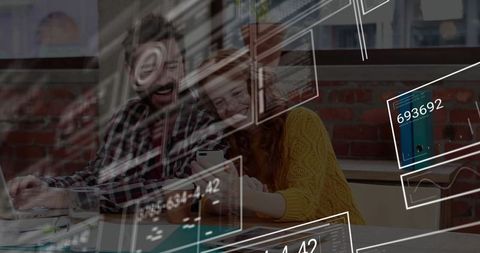 Happy team collaborating on digital project in modern workspace