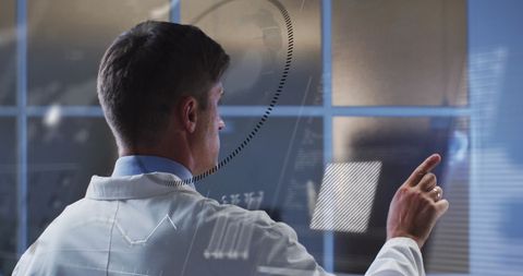 Businessman interacting with digital data systems