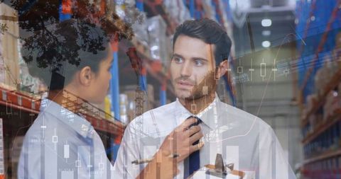 Warehouse Workers Analyzing Data Trends for Improved Efficiency