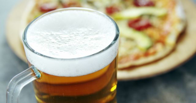 Close-Up of Beer Mug with Pizza in Background - Download Free Stock Images Pikwizard.com