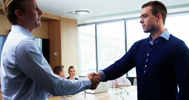 Two Businessmen Shaking Hands in Modern Office During Meeting - Download Free Stock Images Pikwizard.com