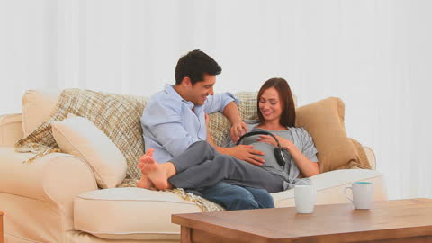 Couple Bonding Over Music for Expecting Baby