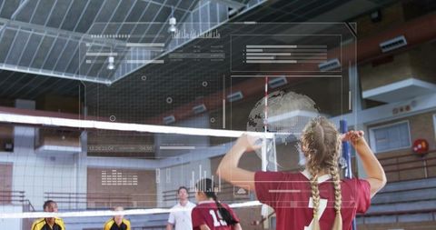 Teen girl blocking at volleyball net in gymnasium wearing maroon jersey and braids
