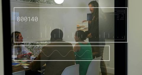 Creative Team Holding Magazine During Interactive Presentation in Modern Conference Room