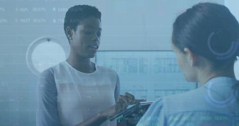 Businesswomen Analyzing Data in Futuristic Office Environment - Download Free Stock Images Pikwizard.com