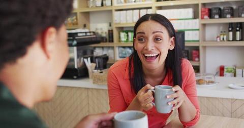 Laughing Woman Enjoying Coffee with Friend in Cafe - Download Free Stock Images Pikwizard.com