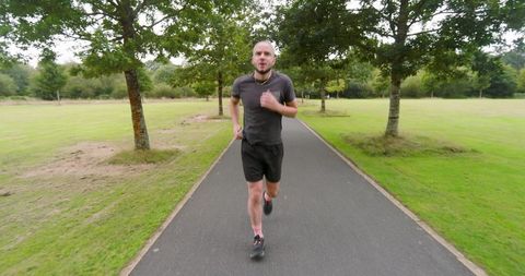 Man Jogging on Park Path for Outdoor Fitness - Download Free Stock Images Pikwizard.com