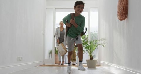 Cheerful Boy Running Indoors with School Bag - Download Free Stock Images Pikwizard.com