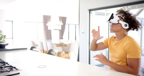 Man Using VR Headset Interacting in Modern Kitchen Environment