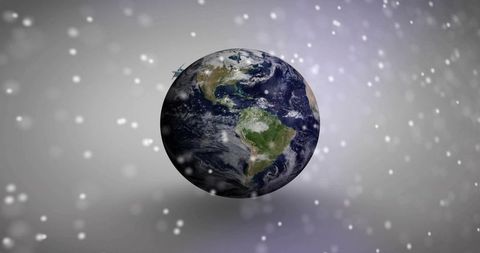 Floating Real Earth Rotating Above Soft Bokeh and Snow Particles with Subtle Halo