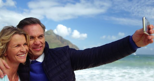 Smiling Couple Taking Selfie at Beach with Ocean View - Download Free Stock Images Pikwizard.com