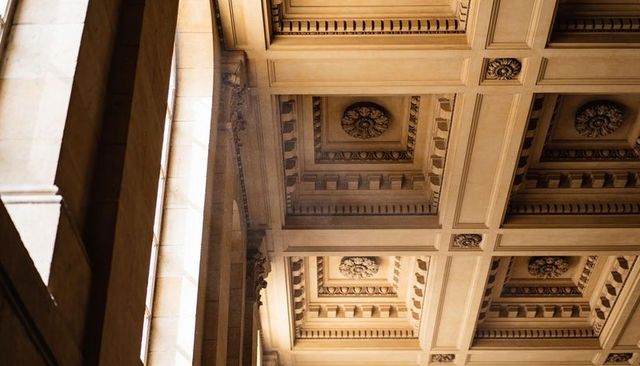 Beaux-arts coffered ceiling with rosette medallions, pilasters and clerestory light