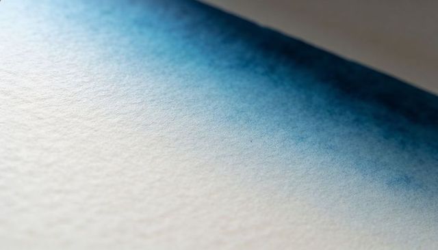 Diagonal blue watercolor wash on textured paper with indigo gradient and granulation