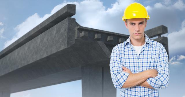 Digital composite image of male engineer standing with arms crossed against under construction bridge