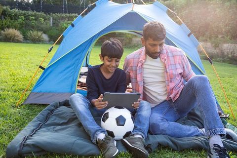 Asian Father and Son Enjoying Outdoor Technology