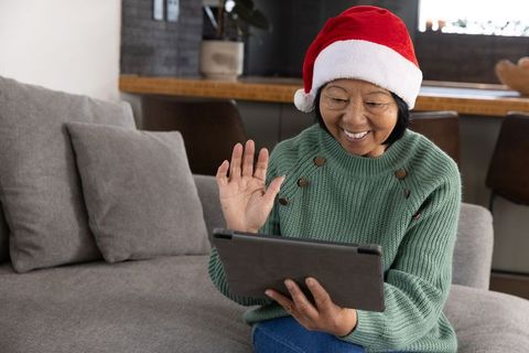Senior Woman Video Calling with Santa Hat in Festive Home Environment