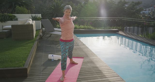 Mature Woman Practicing Yoga on Outdoor Deck Near Swimming Pool - Download Free Stock Images Pikwizard.com