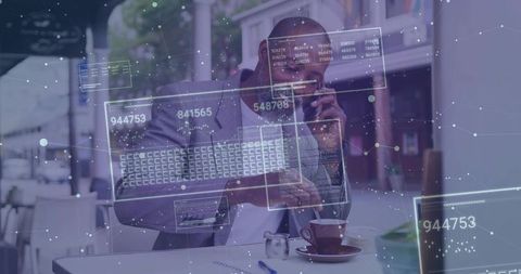 Black businessman talking on smartphone while using laptop at sidewalk cafe with augmented reality d
