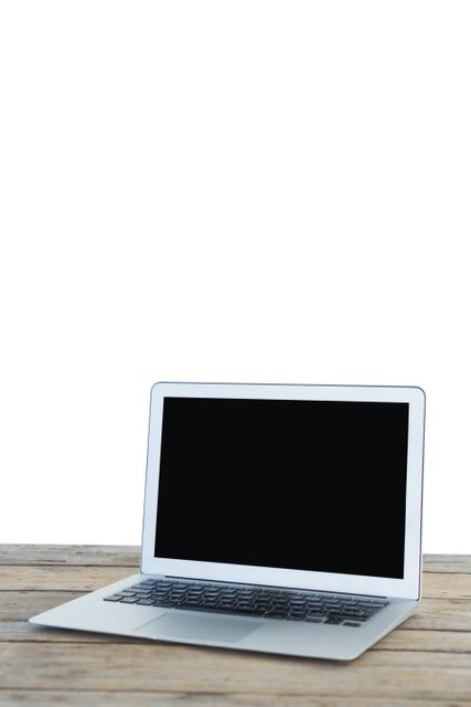 Laptop computer on wooden table against white background
