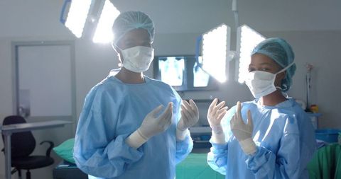 Surgeons Preparing in Brightly Lit Operating Room