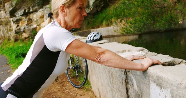Middle-aged Woman Leaning on Wall After Bicycle Ride - Download Free Stock Images Pikwizard.com