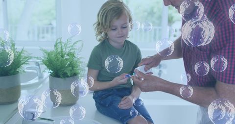 Young Boy Brushing Teeth With Caregivers Anticipation of Health Concerns