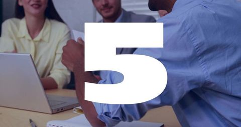 Leaning man discussing with colleagues over laptop and notebook during team meeting