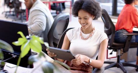 Entrepreneur engaging with tablet in contemporary open office