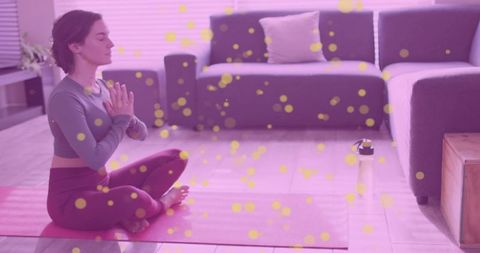 Woman practicing mindful meditation at home on yoga mat