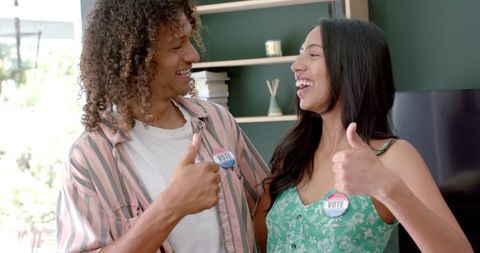 Young Biracial Couple Celebrating Voting at Home