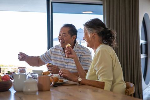 Senior couple enjoying leisurely breakfast at home