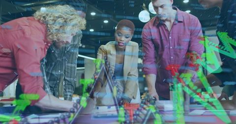 Leading woman guiding team around table with virtual green and red data charts overlay