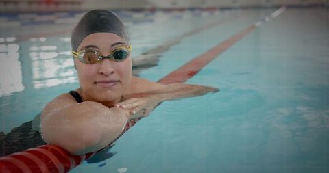 Female Swimmer Relaxing in Competitive Swimming Pool