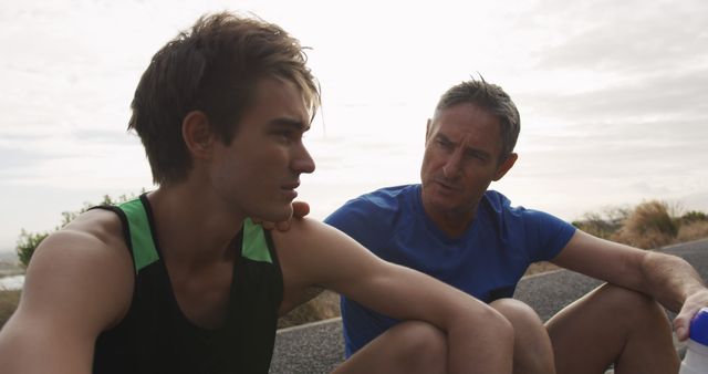 Father and Son Sitting Outdoors Having a Serious Conversation - Download Free Stock Images Pikwizard.com