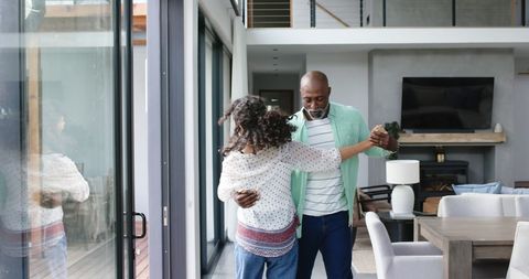 Couple Dancing Joyfully in Modern Living Room - Download Free Stock Images Pikwizard.com